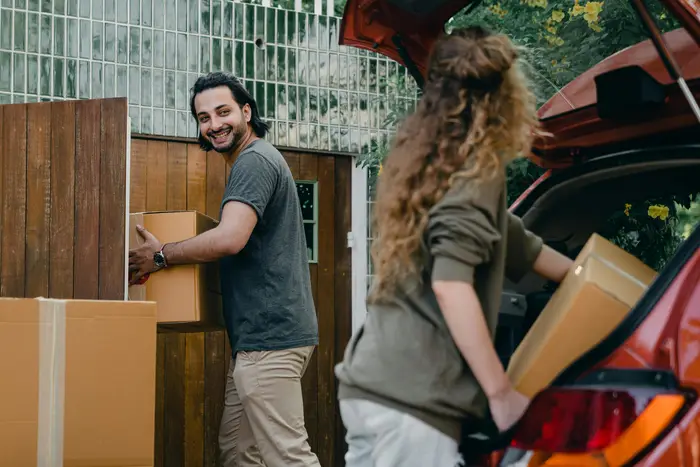 Man and woman loading cardboard boxes during a move
