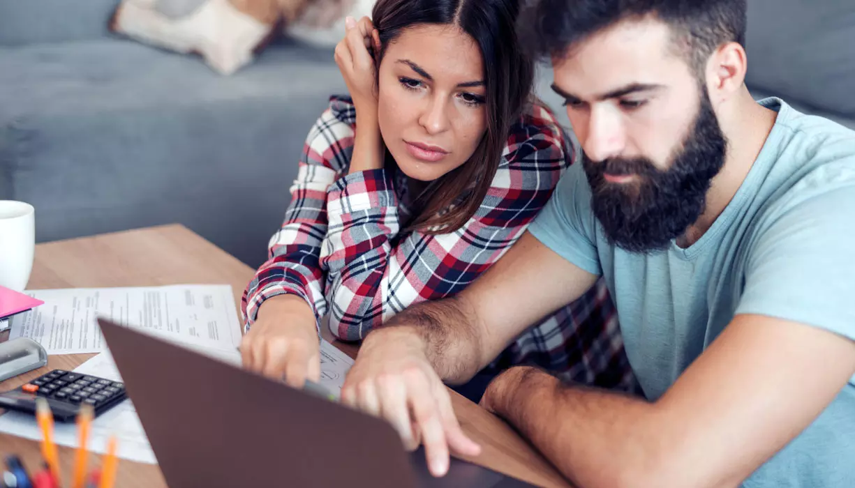 A man and a woman looking at the computer.