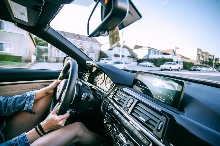Driver’s hands on the steering wheel of a car
