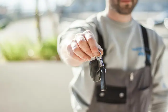 Car rental agent handing over car keys
