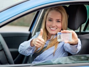Young woman holding her license