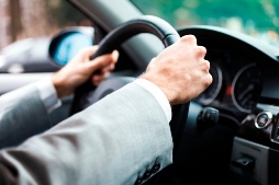 Man gripping steering wheel tightly
