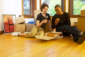 Couple eating on apartment floor